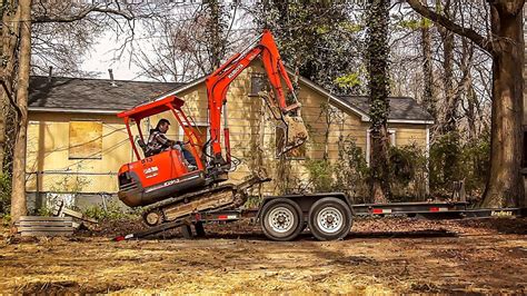 how to strap a mini excavator to a trailer|loading excavators on trailers.